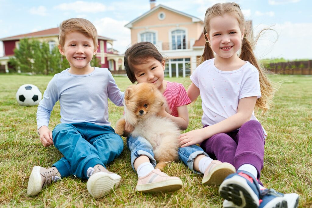Happy Kids Playing with Puppy